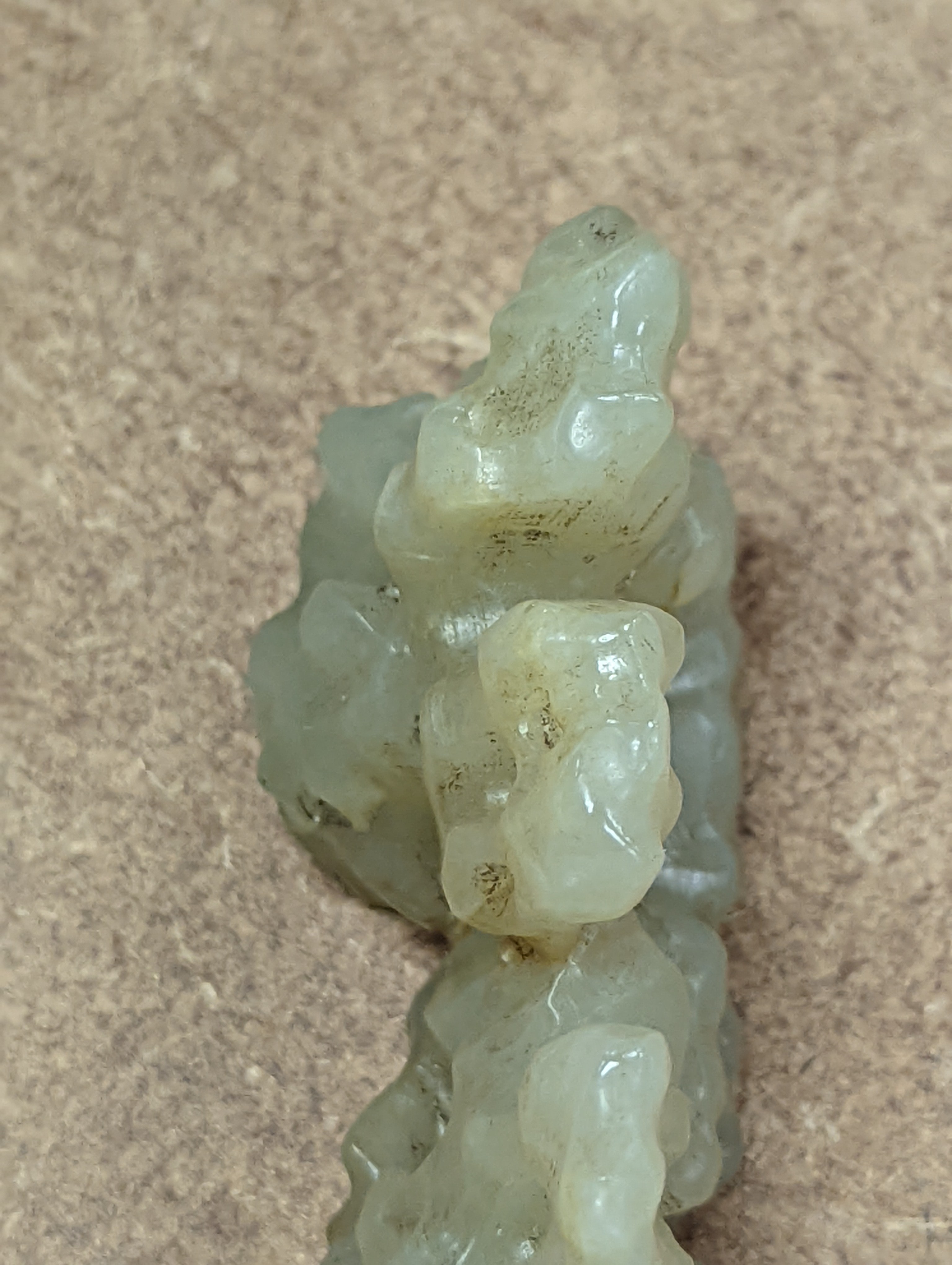 A Chinese celadon jade brush rest, 8cms wide